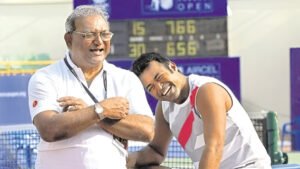 Former Indian hockey player Vece Paes sharing a light moment with his son, tennis legend Leander Paes, during a tennis event.