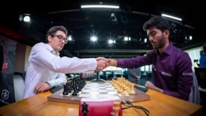 Indian Grandmaster D Gukesh shakes hands with American Grandmaster Fabiano Caruana before their chess match at the St. Louis tournament.
